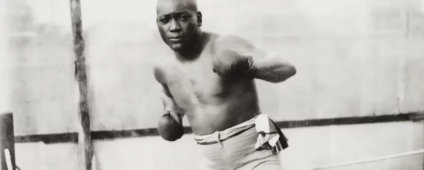 Jack Johnson "The Galveston Giant", doing a boxing pose on the ring.