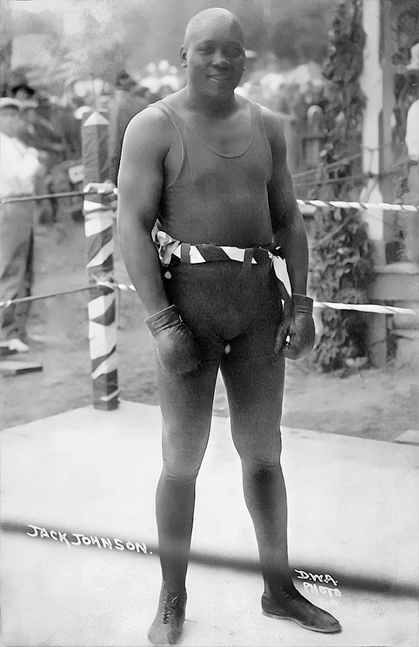 Jack Johnson "The Galveston Giant", posing for the camera on the ring