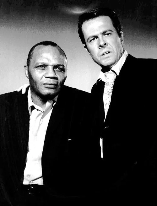 Photo of boxer Jersey Joe Walcott and Robert Culp from the television program Cain's Hundred.