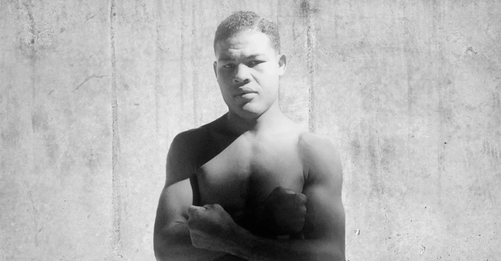 Joe Louis "The Brown Bomber" posing for the camera with his arms crossed