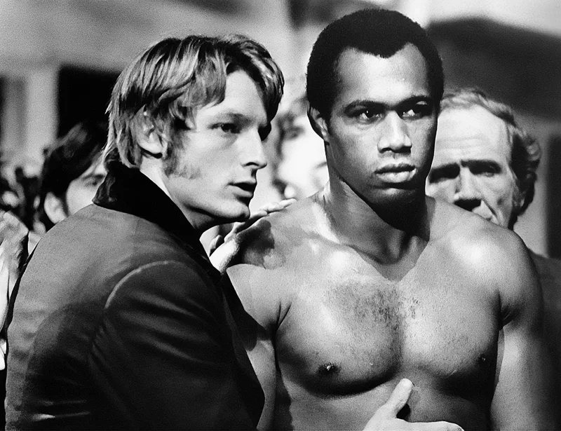 American actor Perry King encouraging American boxer and actor Ken Norton before a fight in the film Mandingo. 1975